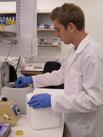 Michael loading DNA tubes in centrifuge.